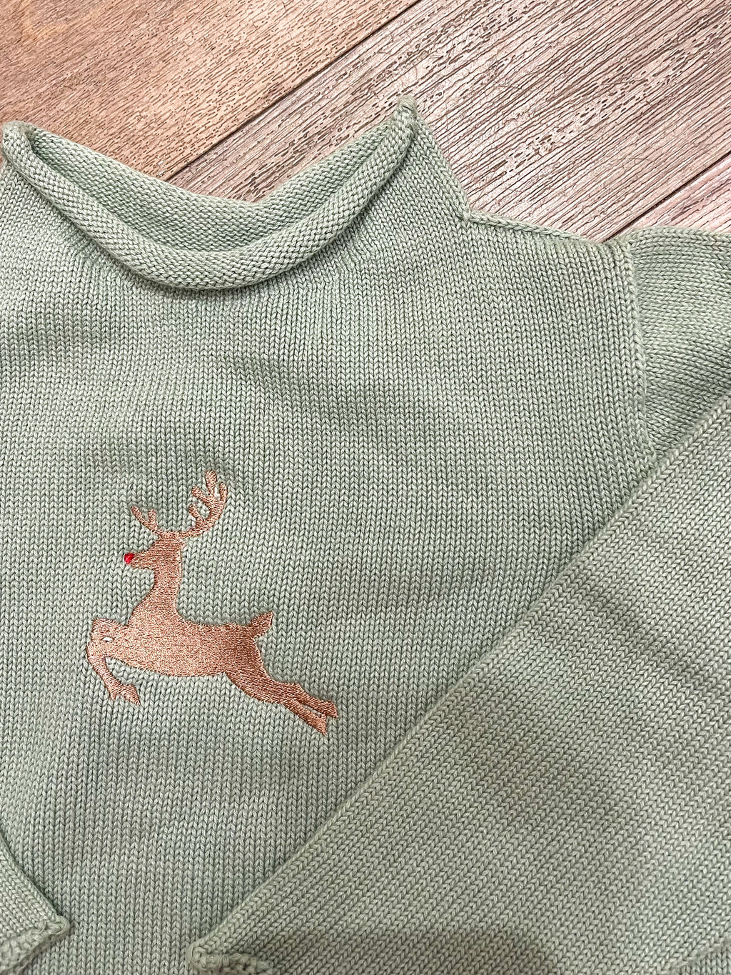 A Soft Idea Roll Neck Sweater in Sage with Reindeer