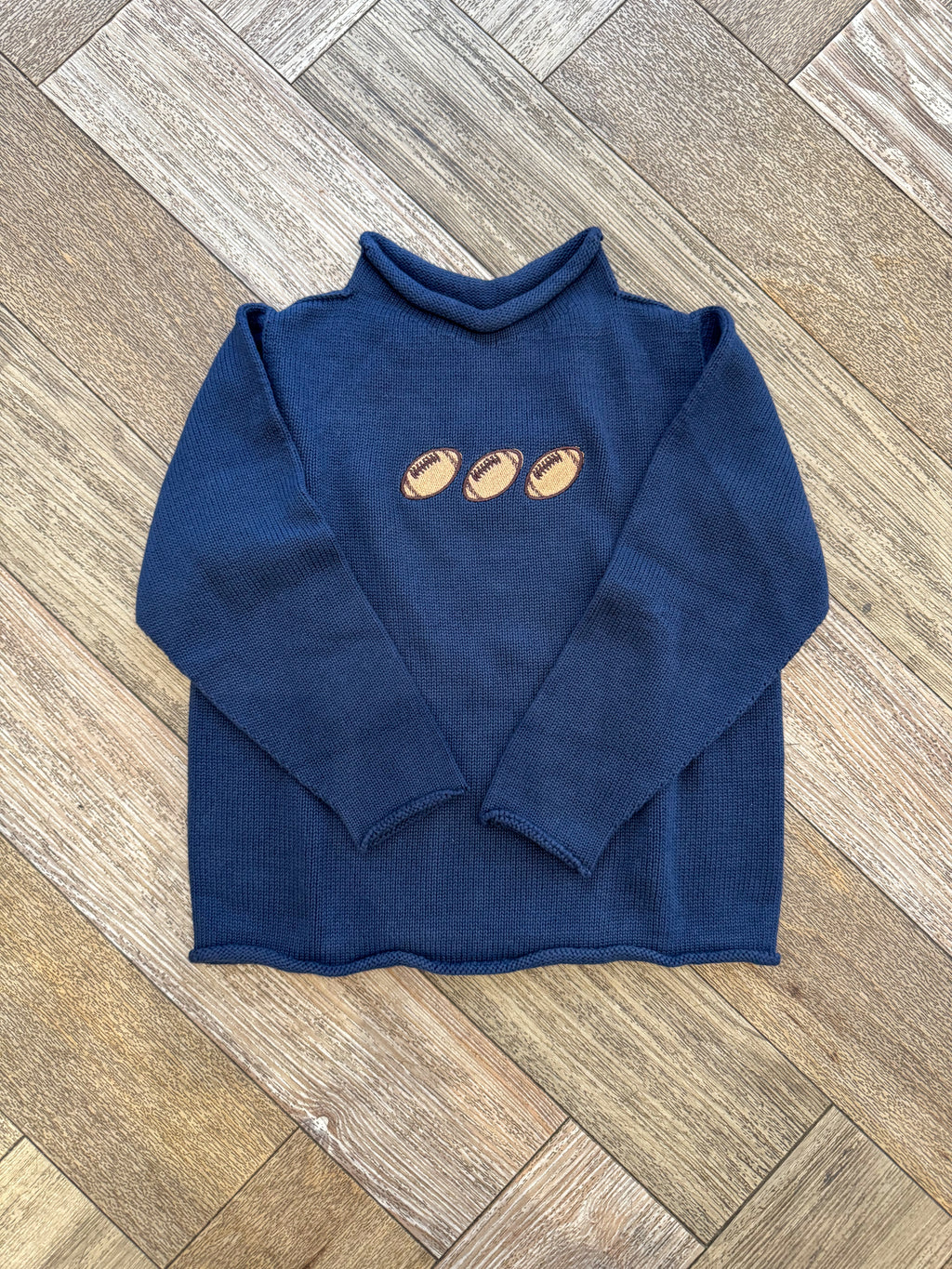 A Soft Idea Roll Neck Sweater in Navy with Football Trio